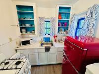 Kitchen with fridge, stove, microwave and more.