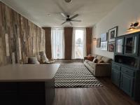 View of the full living area from the kitchen highlighting the large windows