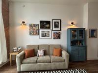 Living Area with pull-out couch, hutch, and original artwork on the walls