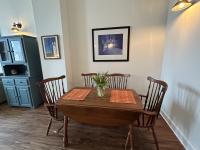 Dining area with large table and original artwork on the walls