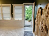 Full bathroom with door leading to large shared patio