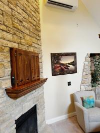 AC unit, TV, and fireplace