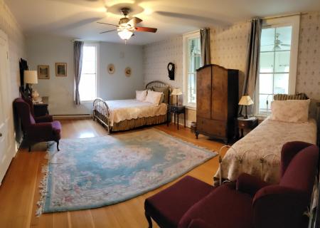 This Room features a Queen bed and a Twin bed